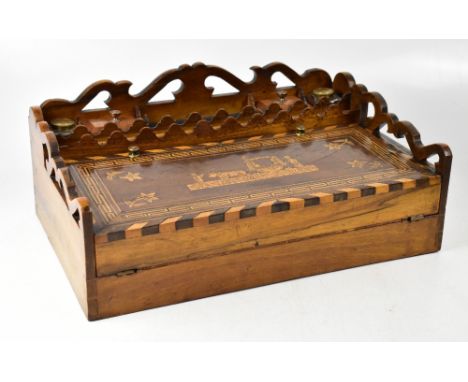 A 19th century Continental inlaid walnut writing slope with pierced gallery and fitted top, with glass inkwells and a ruler s