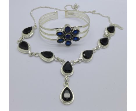 A silver and blue stone bangle and a silver and black stone necklace
