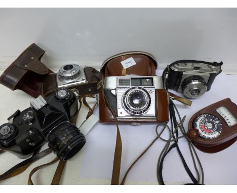 Four film cameras and a light meter including Zenit-E and two Agfa