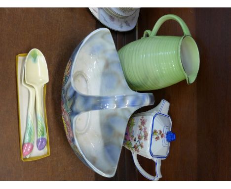 A Sylvac Dovedale basket, a Royal Winton Alphina jug, Carlton Ware salad servers and a Falcon ware teapot and lid