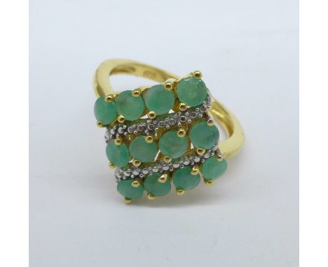 A silver gilt and emerald ring, M