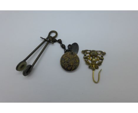 A Victorian skirt lifter and a chatelaine hook with compass fitted