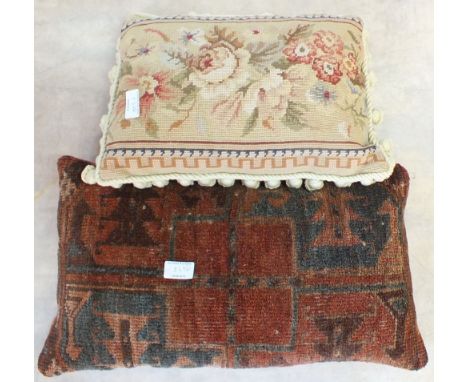 A Persian pattern brown ground rug and two carpet cushions