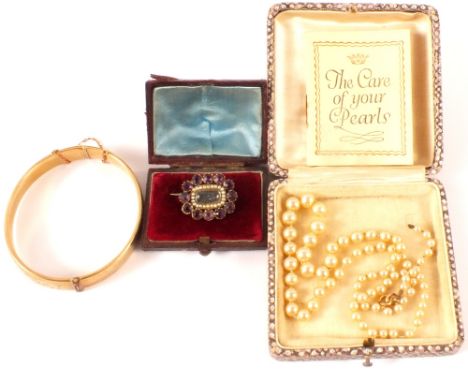 A mixed lot including 9ct gold metal core bangle with inscription, a yellow metal brooch set with purple stones, seed pearls 