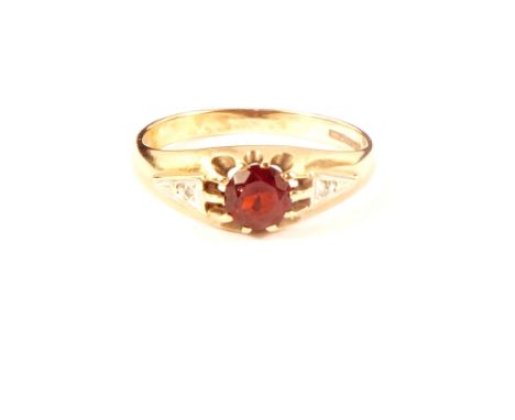 A 9ct gold 'gypsy' style ring set with red stone and small diamonds to shoulders, size U 1/2