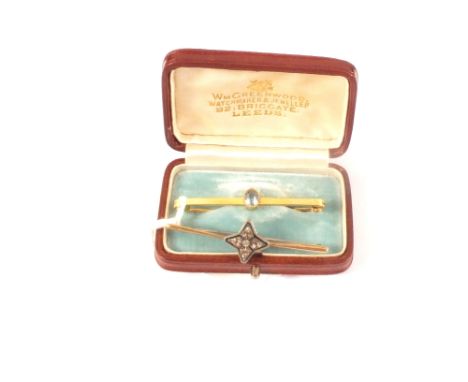 A 9ct gold bar brooch with white metal star motif set with white stones and a 9ct gold bar brooch set with single aquamarine 