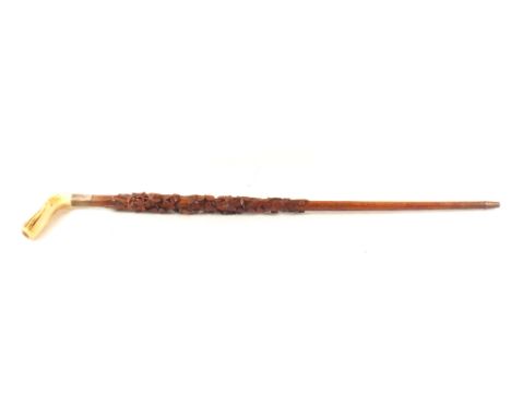 An Irish carved wooden walking stick with horn grip