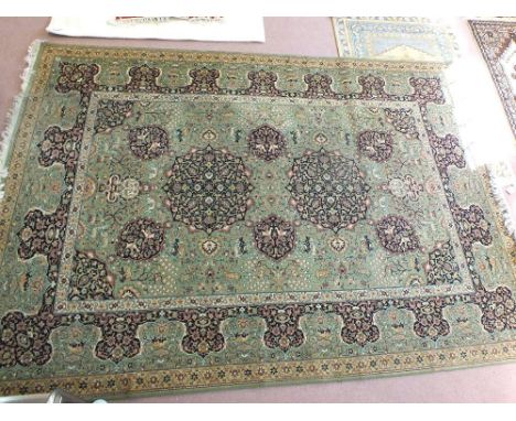 A green and floral Persian pattern carpet, 132" x 97