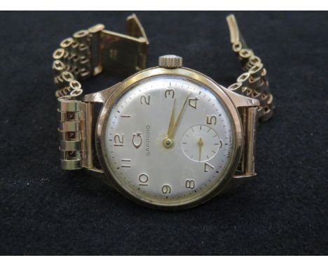 Vintage Garrard wristwatch with 9ct gold case and strap. Manual wind movement keeping good time over a short testing period. 
