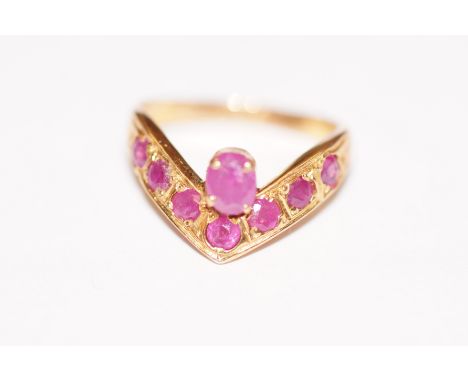 18ct gold "Wish bone" ring set with seven pink stones and a single solitaire pink stone on a raised clasp. Size K