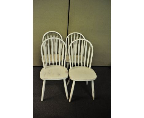 A set of four white painted stick back chairs with later seats