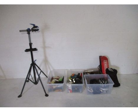 An assortment of bicycle related goods including helmet, bike stand, bike cover, lights, handle bars, tools etc.