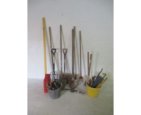 A collection of various tools including shovels, sledgehammers, chains, hand tools etc.