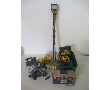 A collection of 110v tools including sanders, Ryobi mitre saw, lights along with a box of various plumbing fittings and fixtu