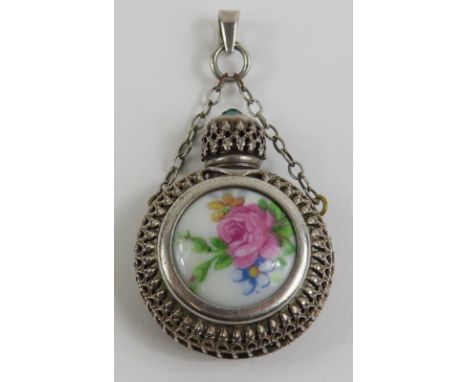 A continental white metal scent bottle, with a painted porcelain panel to the centre, marked 'Limoges', the top set with a gr