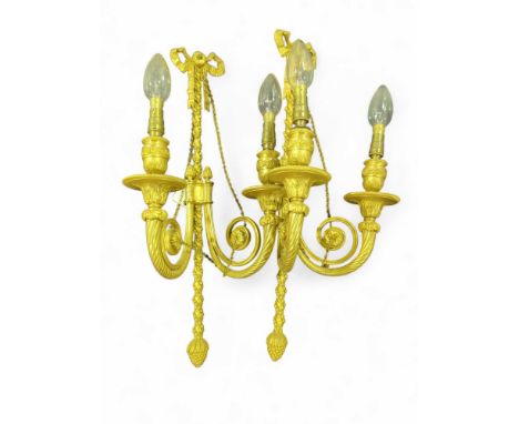A pair of French style gilt metal twin branch wall light fittings, decorated with ribbons, flora and fauna and chain accents