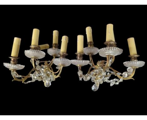 A 20th century brass and glass twelve branch chandelier, together with two gilt metal wall light fittings with crystal drops