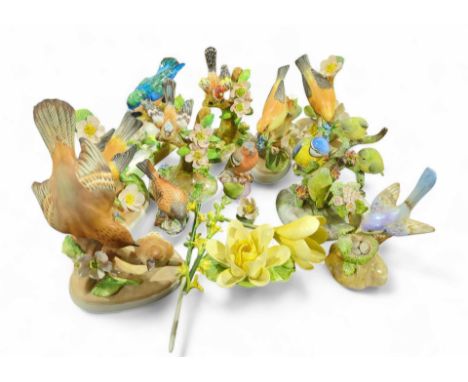 A Crown Staffordshire model of a Kingfish above a small pool of water, designed and modelled by J T James; together with nine