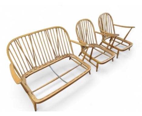 A mid-20th century Ercol two seat sofa frame and two matching arm chair frames, all with stick backs, the sofa 78cm high, 134