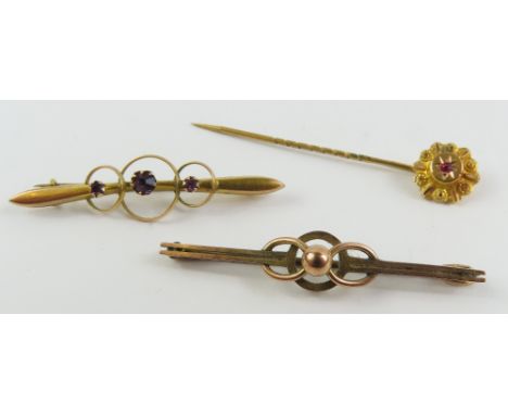 Two early 20th century bar brooches, both marked '9ct', together with a stick pin, in an associated case