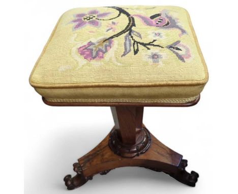 A Victorian walnut adjustable piano stool, with tapestry seat, and on three scrolling feet