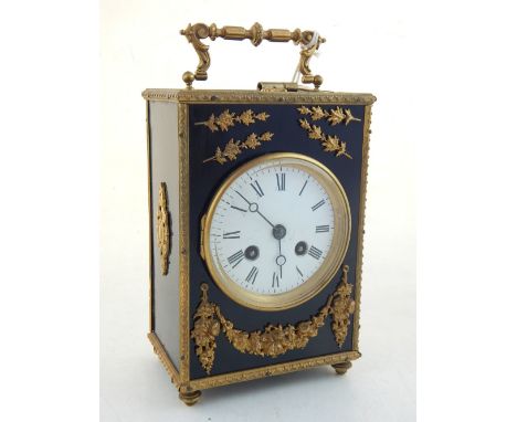 A late 19th century French gilt metal mounted ebonised mantel clock, the eight day movement striking on a bell, white enamel 