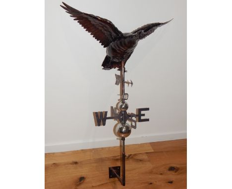A beaten copper weather vane, modelled as a goose in flight over directional arrow on chromed ball shaft. H. 90cm