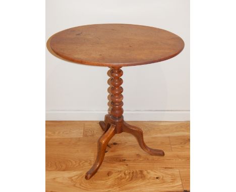 An oval mahogany wine study table, 19th century, bobbin turned stem, on tripod base. W. 58cm