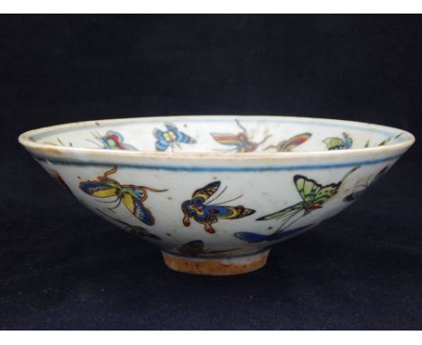 A Chinese ceramic footed bowl, painted with exotic butterflies, bears red seal mark to base. H. 6.5cm D. 17cm