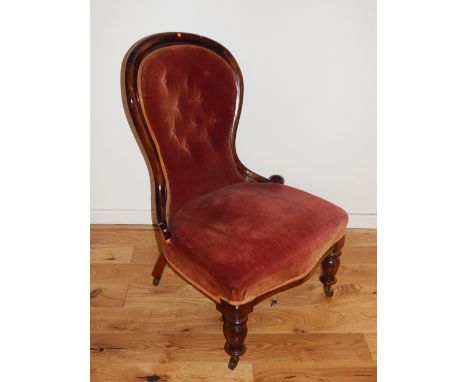 A Victorian mahogany and button upholstered spoon back chair.