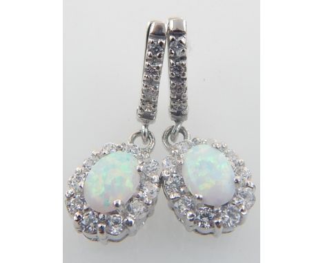 A pair of silver, cubic zirconia and opal drop earrings. 