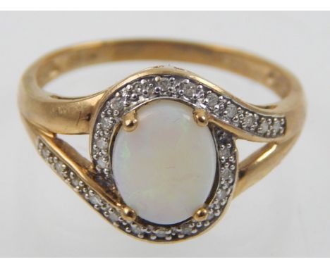 A 9ct yellow gold diamond and opal ring.