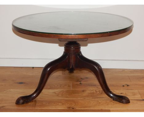A George III mahogany tripod table, the circular top above a shortened support and tripod base with pointed pad feet, D. 74cm