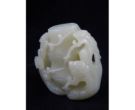 A Chinese jade paperweight, carved as a tree trunk with blossoming flowers. H. 7cm