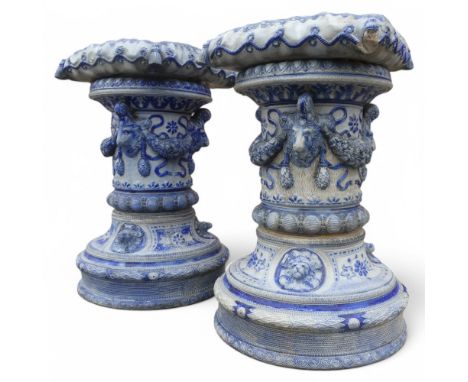 A near pair of Victorian blue and wight ceramic Westerwald garden seats / plant stands. Width 35cm, height 56cm.