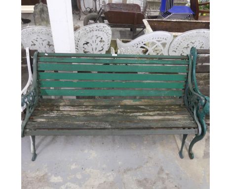 A painted slatted teak garden bench with cast iron ends. Length 127cm, height 70cm, depth 58cm.