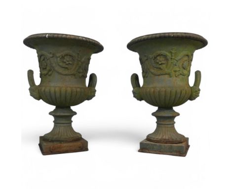 A pair of painted cast iron Medici style garden urns, one with impressed badge for Britannia Foundry, Derby. Diameter 45cm, h