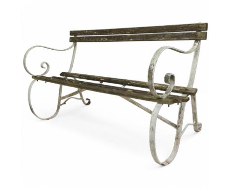 A weathered teak slatted garden bench with scrolled cast iron ends. Length 132cm, height 78cm, depth 65cm.