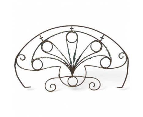 An antique wrought iron fan design wall ornament. Width 125cm, height 71cm.Possibly originally had glass panels.