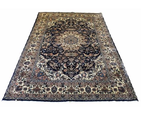 FINE ISPHAHAN DESIGN CARPET, 280cm x 188cm, central medallion on a midnight blue palmette and vine field within complimentary