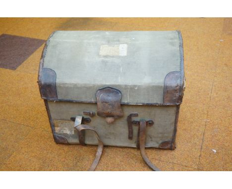 An early 20th century domed top steamer trunk, thewicker body covered with light green canvas, withoriginal brown leather han