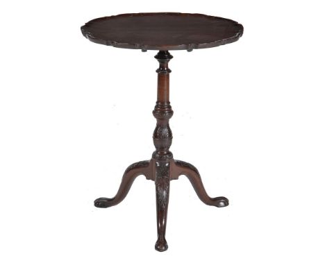 A mahogany tilt top table, circa 1780 and later, the piecrust top on turned and leaf carved column and leaf carved tripod bas