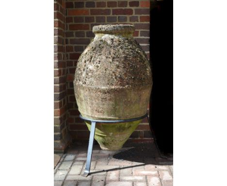 A Mediterranean terracotta pithos jar, early 20th century, of ovoid form with ring neck; held in a later wrought iron stand  