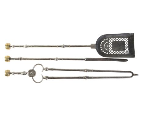 A set of late George III or Regency steel and brass mounted fire irons, circa 1815, comprising shovel, poker and tongs, all w