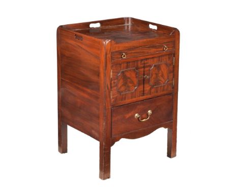 A George III mahogany bedside night commode, circa 1800, the tray top above frieze drawer, pair of cupboard doors and drawer,