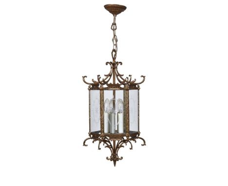 A gilt metal and glazed hall lantern in George III Chinoiserie taste, mid 20th century, of hexagonal section with scrolled st