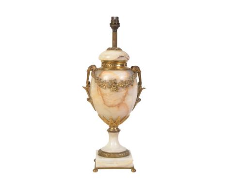 An onyx and gilt metal mounted urn table lamp, 20th century, the fitment and domed cover above an ovoid body with twin upscro