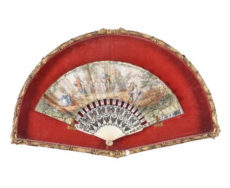 A printed and hand tinted paper and carved bone fan in Louis XVI taste, mid 19th century, the leaf with Watteauesque scenes w