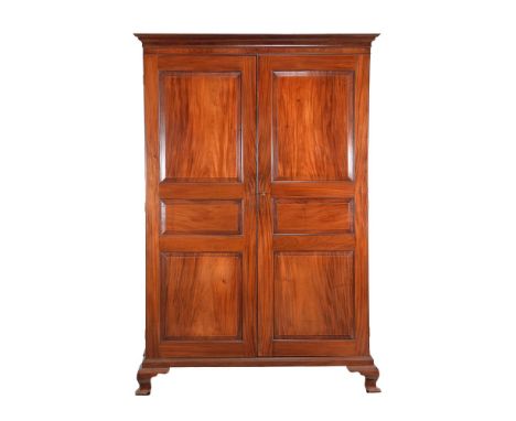 A George III mahogany press cupboard, circa 1800, probably Channel Islands, the panelled doors enclosing shelf and hanging ra