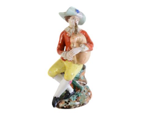A Moscow porcelain (Popov Factory) model of a man playing bagpipes, mid 19th century, modelled after the Meissen Commedia del
